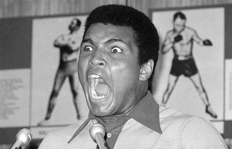 FILE - In this Aug. 29, 1974, file photo, boxer Muhammad Ali makes a face during a press luncheon in New York, to promote the sale of tickets to Madison Square Garden where the battle against George Foreman in Zaire will be shown in October on closed circuit television. Ali turns 70 on Jan. 17, 2012. (AP Photo/Ron Frehm, File)